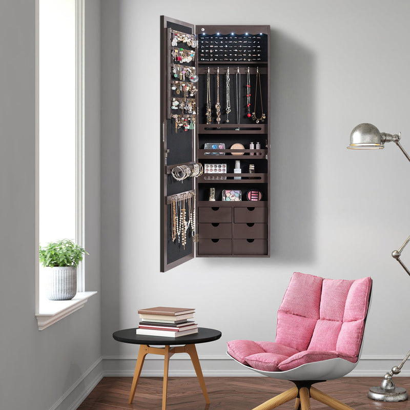Standing jewelry armoire with mirror in bedroom