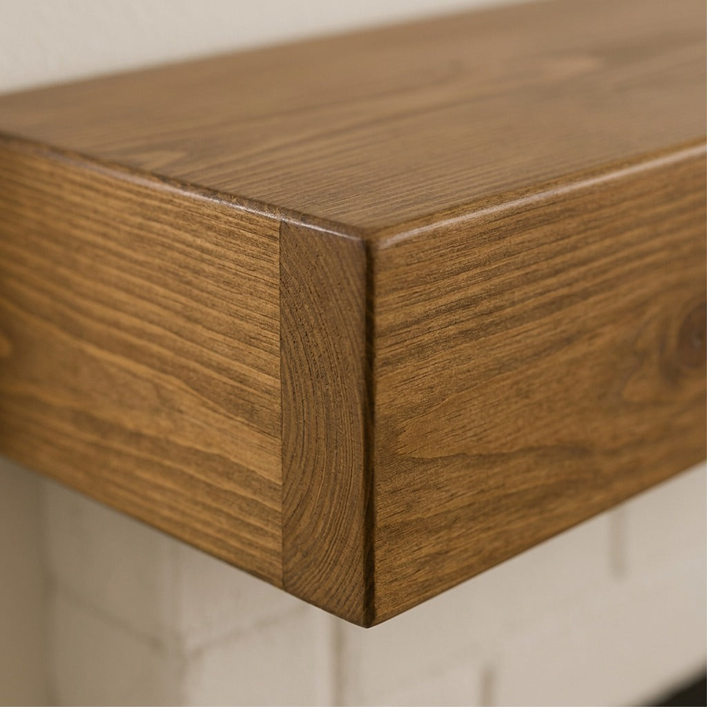 Close-up of the Entrepot La Grange floating fireplace mantel corner in Whiskey Brown wood finish.