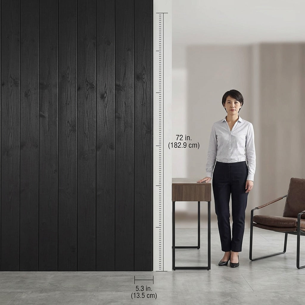 Scale reference of Entrepot La Grange black solid pine wall paneling beside a standing person.