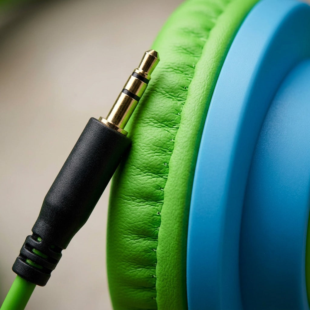 Close-up of the Wicked Audio Rad Rascal gold-plated 3.5mm plug and green padded headphone earcup.